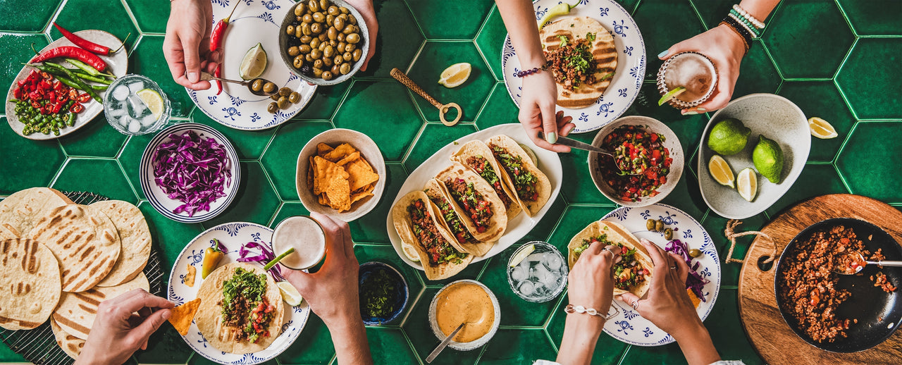 Friends sharing tacos with fresh salsa at a table